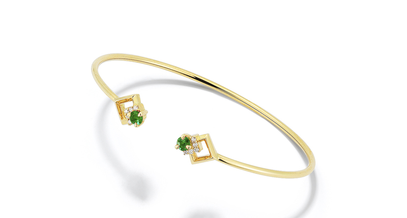 A cuff style in 18-karat yellow gold with emeralds and white diamonds ($1,600)