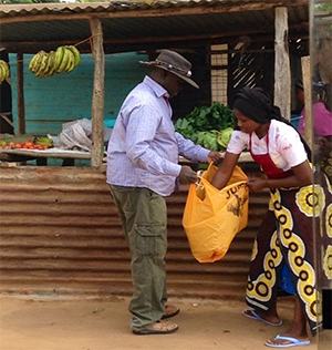 Okeno liked to stop at the stall of one woman in particular to buy bananas because her husband had died in a mining accident and that was her family’s income. He was always looking out for people. (Photo credit: Debra Navarro)