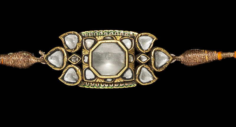 This 19th century diamond-set enameled armband (bazuband) features a central octagonal-shaped diamond surrounded by smaller diamonds in the form of a stylized flower head and flanked by diamond-set floral motifs in an open framework. It could garner as much as $17,000.