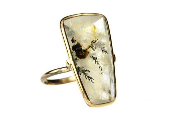 Russell Jones’ “Dendritic Pinch” ring features a shield-shaped buff top dendritic quartz set in 14-karat gold ($1,350).<br />
<a href="http://www.russelljonesjewelry.com/" target="_blank"><span style="color: rgb(255, 0, 0);">russelljonesjewelry.com</span></a>
