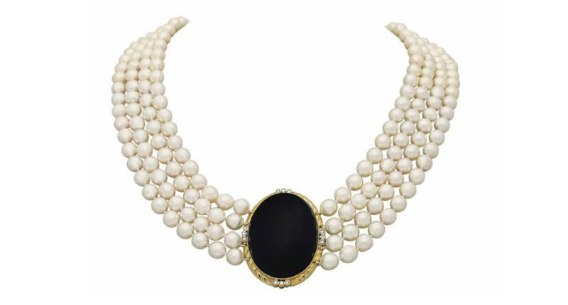 A four-strand cultured pearl necklace centered on a bezel-set oval onyx cabochon, within a 14-karat gold and circular-cut diamond surround, went for $40,000.