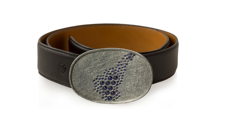 <a href="http://www.toddreed.com" target="_blank" rel="noopener noreferrer">Todd Reed’s</a> sterling silver with patina belt buckle features 13.41 carats of blue sapphires and raw diamond cubes on a brown leather belt ($14,080)