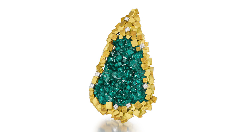 This pendant from 1973 was part of the “Sticks and Stones” collection. It is comprised of a large green dioptase crystal set within a border of overlapping gold squares of matte and textured finish and eight square-cut diamonds, mounted in 18-karat yellow gold ($15,700 and $23,500).