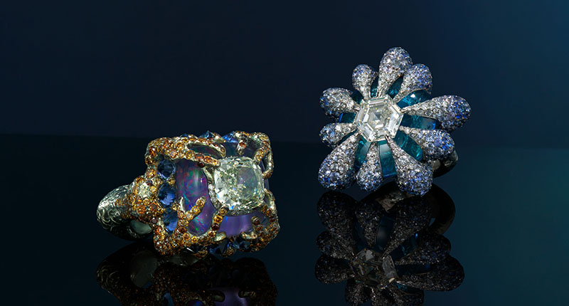 At left is a green-yellow diamond and multi-gem ring ($45,000 to $70,000) and at right is another multi-gem ring from Chan ($50,000 to $80,000)