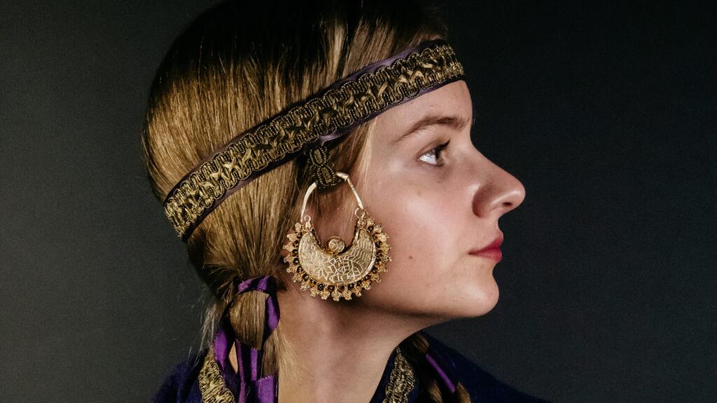 A recreation of how the earrings may have been worn, attached to a hood or headband (Photo © Archeology West-Friesland/Fleur Schinning)