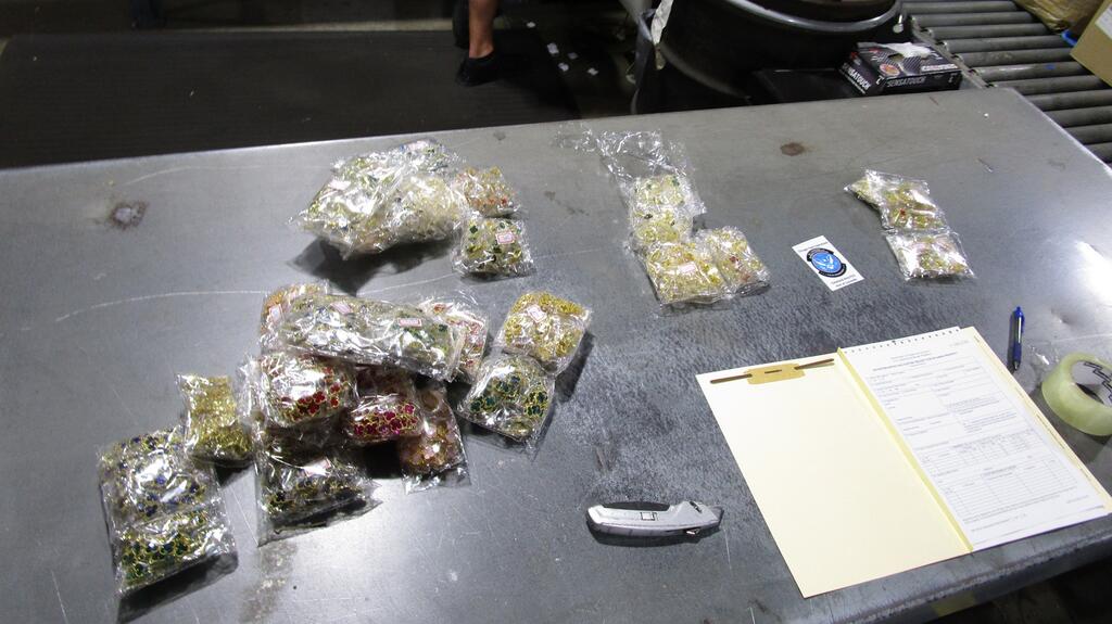 This image provided by U.S. Customs and Border Protection shows some of the counterfeit Van Cleef & Arpels “Alhambra” jewelry seized by agents. Counterfeit Van Cleef & Arpels “Alhambra” jewelry