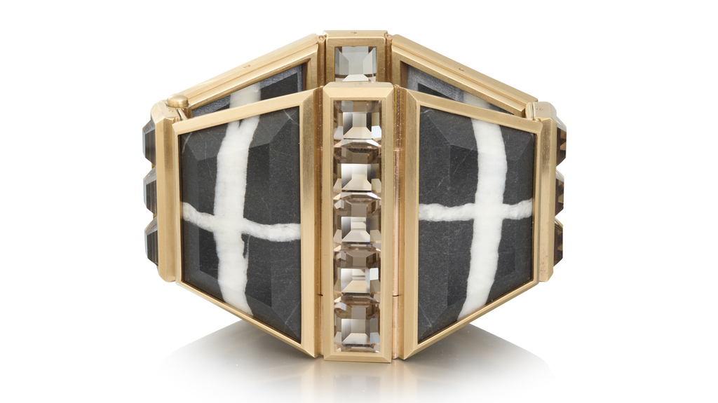 Cuff bracelet in bronze with gold hinges featuring pebbles and smoky quartz ($50,700)