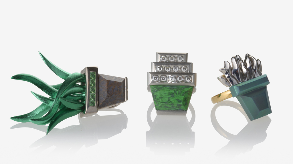 At left, an earring with fossilized dinosaur bone pot, green aluminum plant, and tsavorite accents set in white gold (sold as pair for $23,700); at center, the “Stacked Pots” ring with diamonds and Maw Sit Sit set in platinum ($42,300); and at right, titanium, gold, and platinum ring ($5,200)