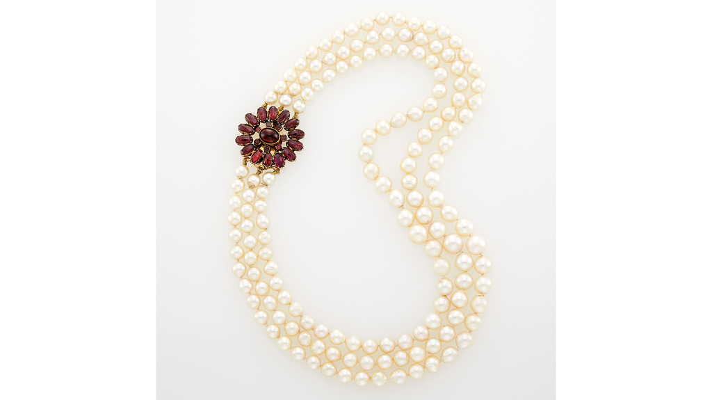 This pearl necklace, once belonging to actress Celeste Holm, features a gold and garnet clasp. This pearl necklace, once belonging to actress Celeste Holm, features a gold and garnet clasp.
