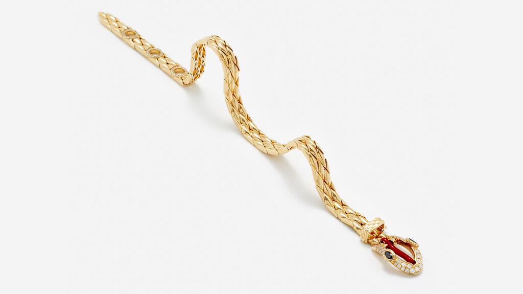 The “Python Gold” bracelet depicts a snake belt buckle with black diamond eyes, a red enamel tongue, and gray diamond accents set in 9-karat yellow gold ($8,710) Yvonne Léon Gold Python Bracelet Unbuckled
