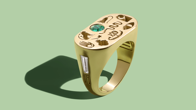 A custom “LoverGlyphs” ring in 18-karat yellow gold with emerald diamonds (custom pricing begins at $4,200)