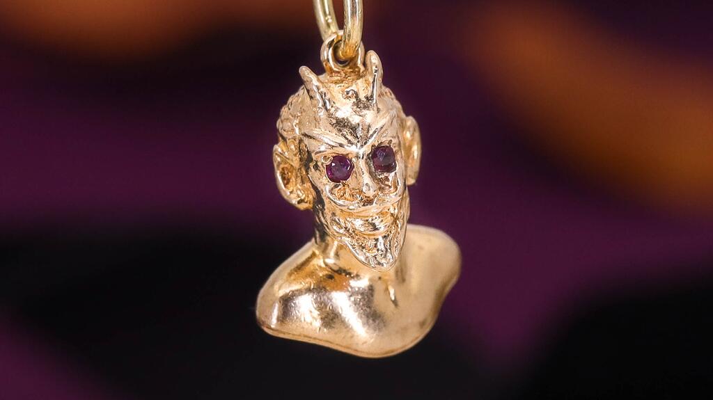 A devil charm from Trademark Antiques with ruby eyes Devil charm