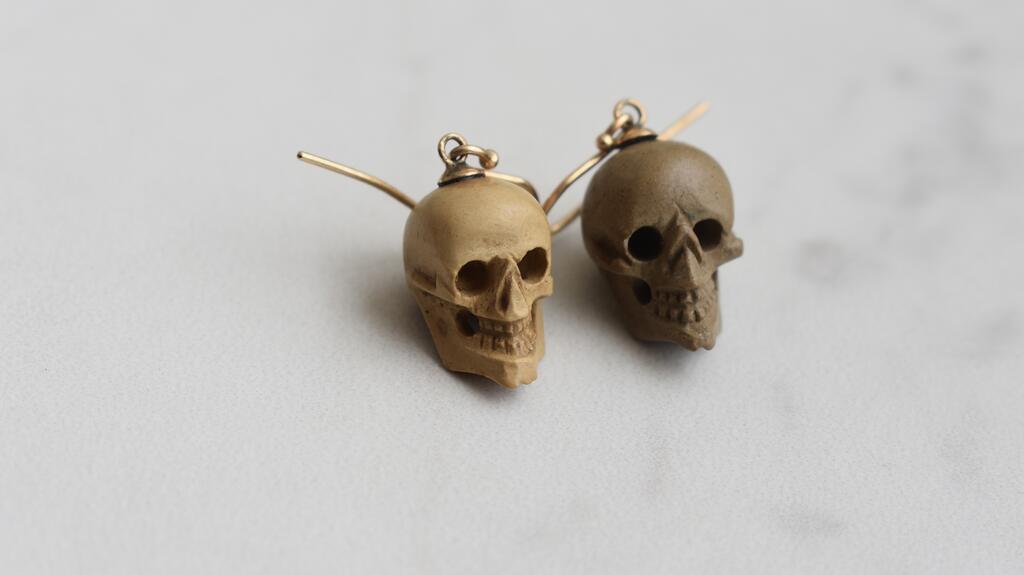 A pair of carved lava skull earrings from Alexa Rosen Antiques Carved lava skull earrings