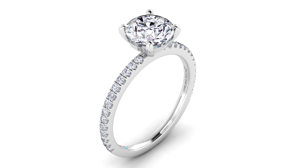 A Smiling Brides round lab-grown diamond engagement ring with the diamond pavé shank. It’s available with a center stone weighing between 1 and 3 carats.
