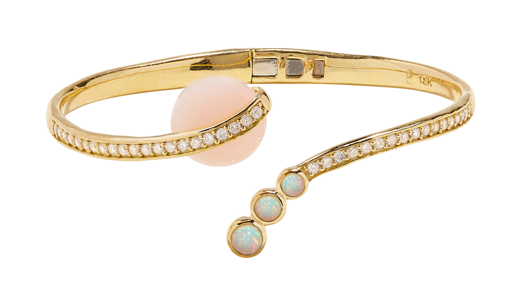 Pamela Love “Comet Cuff” in 18-karat yellow gold with pink opal, white opal, and white diamonds ($7,500)