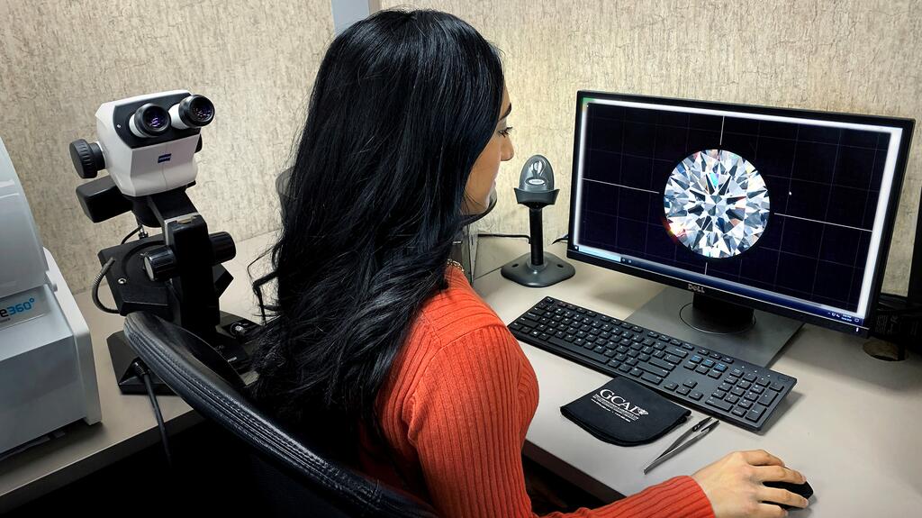 GCAL employee looking at a diamond