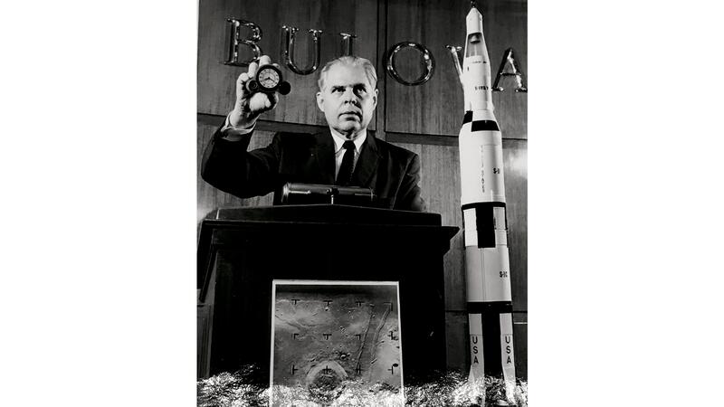 E. Van Haaften holding Bulova clock