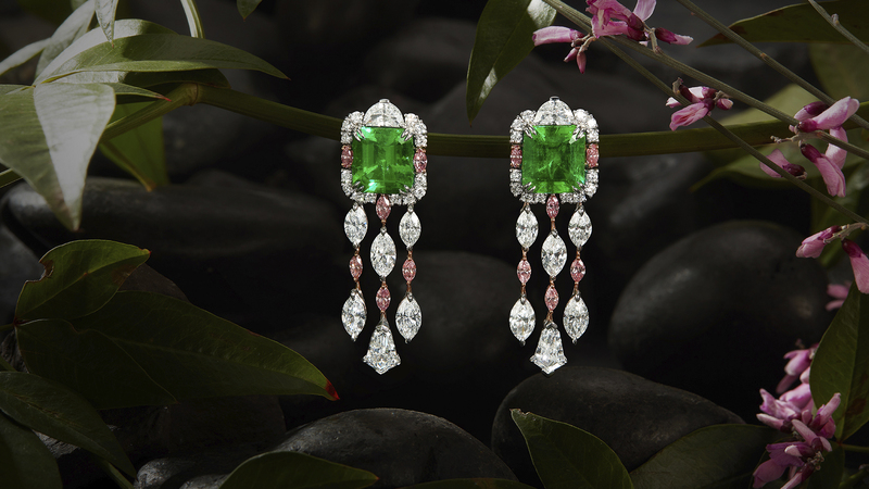 The “Cattaleya” earrings are set with no-oil octagonal step-cut emeralds weighing 3.38 and 3.89 carats accented by 6.76 carats of white diamonds, 0.79 carats of pink diamonds, and 0.10 carats of blue diamonds in a platinum and 18-karat white gold setting.