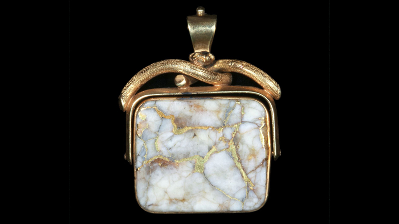 This gold pendant with a piece of gold-bearing white quartz mounted in a frame that allows the stone to spin sold for $11,100 against an initial estimate of $2,000.