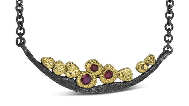 <a href="https://ronafisher.com/products/wavy-pebbles-bar-necklace-with-rubies" target="_blank"> Rona Fisher </a> “Wavy Pebbles Bar Necklace” with rubies in 18-karat yellow gold and oxidized sterling silver ($1,095)
