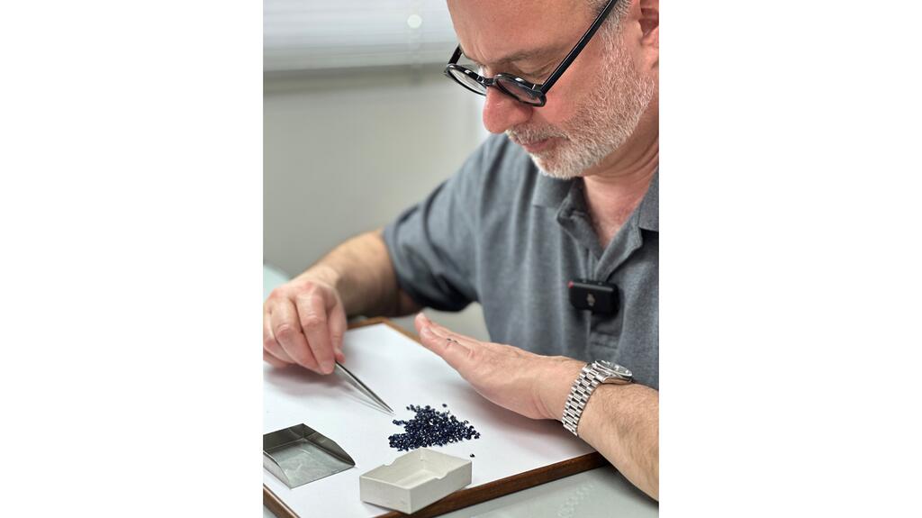 Jeff handpicks the gemstones that come into Reeds Jewelers, meticulously inspecting each stone for specific qualities that meet the store’s standards. Jeff Zimmer sorting gemstones