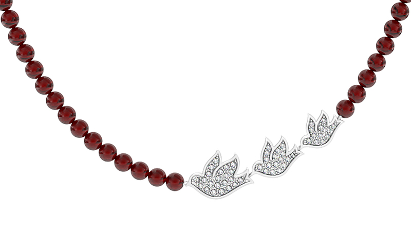 <a href="https://girlupcollection.com/collections/dove/products/flight-necklace-with-diamond-doves-on-ruby-beads-21076" target="_blank"> Girl Up Collection </a> “Flight” Necklace with responsibly sourced diamonds on ruby beads in sterling silver ($500)
