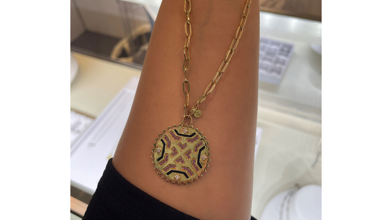 This 14-karat gold reversible medallion necklace is set with diamonds and pink sapphires ($8,500).