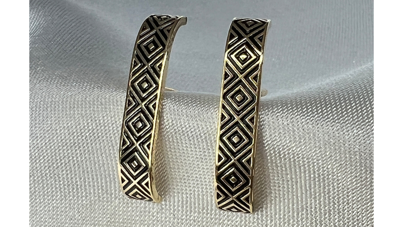 A pair of criss-cross black enamel suspender cuff earrings, available in 14- and 18-karat yellow, white or rose gold ($1,300 to $1,700)