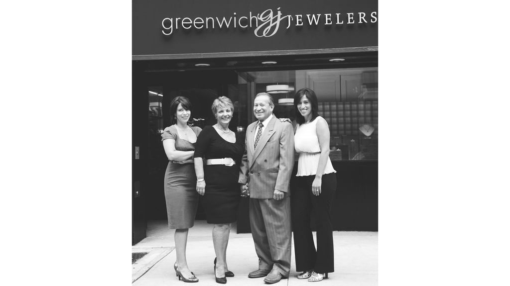 Jennifer Gandia, far left, and Christina Gandia Gambale, with their parents outside their store on Trinity Place, where it moved to after 9/11.