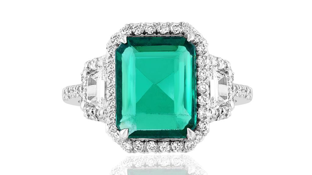 Jewels by Jacob platinum ring with 3.58-carat Zambian emerald flanked by two trapezoid-shaped diamonds totaling 0.42 carats and featuring 58 round diamonds totaling 0.64 carats