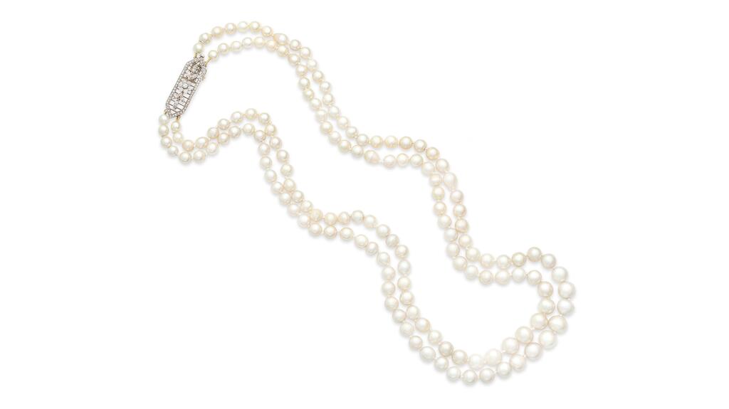 A necklace featuring two strands of natural saltwater pearls graduating in size towards the center and an openwork lozenge-shaped clasp with floral, foliate, and knifewire detail, set with old brilliant and rose-cut diamonds. pearl and diamond necklace
