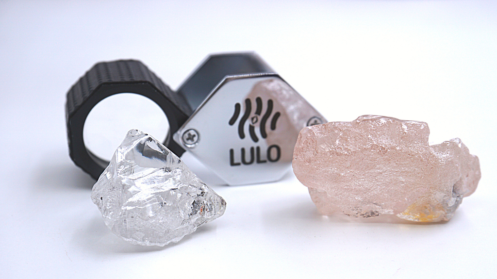 “The Lulo Rose” next to an 80-carat white diamond also mined at Lulo (Photo courtesy of Lucapa Diamond Company Ltd.)