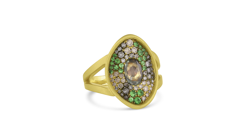 The Camo collection’s “Amani” pavé ring in 18-karat satin-finished yellow gold features a 0.68-carat rose-cut green sapphire at center with gray diamonds (0.31 carats), champagne diamonds (0.27 carats), and tsavorites (0.29 carats) pavé.