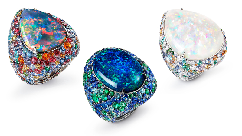 From left to right: Ring set with 10.38-carat pear-shaped cabochon Australian opal, rubies, pink, orange, yellow and blue sapphires, red garnets, tsavorites, and diamonds in white gold; ring set with 30.98-carat oval-shaped cabochon black Australian opal, sapphires, Paraiba tourmalines, tsavorites, and emeralds in white gold; and ring set with 50.95-carat pear-shaped cabochon white Ethiopian opal, blue, yellow and pink sapphires, tsavorites, orange and green garnets, emeralds, blue tourmalines, and diamonds in white gold.