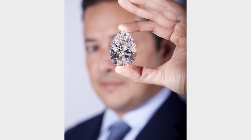 Here, Christie’s International Head of Jewelry Rahul Kadakia showcases the 228-carat “The Rock” diamond.