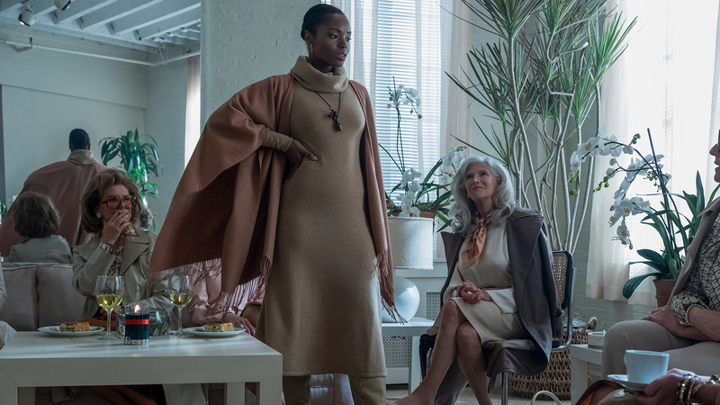 Later that same episode, model Bethann Hardison, played by Megan Danielle Gerald, wears the bottle as a necklace in a fashion show. (Photo credit: Jojo Whilden/Netflix ©2021)