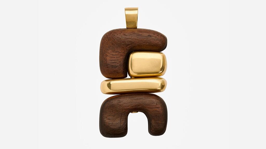 The “Earth Totem” pendant by Joelle Kharrat with natural wood and 18-karat yellow gold ($4,800) Joelle Kharrat Earth Totem Pendant