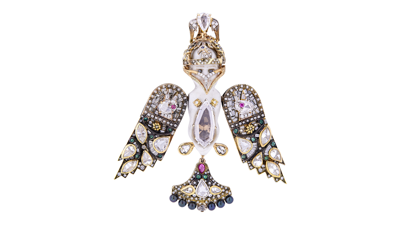 Castro’s “Antique Bisque Doll” was presented at Sotheby’s New York’s “Brilliant & Black” sale in September 2021. Handmade in Geneva, it took 600 hours to make and was realized over two years. The pendant’s shield wings vibrate in the style of “en tremblant” jewelry. The bird’s mask opens and closes and can be removed to show the antique doll’s face. Featuring enamel, emeralds, rubies, Akoya pearls, and diamonds in 18-karat gold and sterling silver, the piece’s largest stones are a 1.5-carat Type IIa diamond and a 2.83-carat brown diamond.