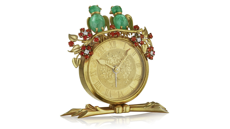 A Van Cleef & Arpels “Inseparables” desk clock, New York, circa 1940 with emeralds, diamonds, and rubies mounted in 18-karat gold. ($7,000-$9,000)