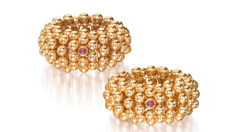A pair of gold bracelets by Demner, New York, composed of 18-karat gold and ruby ($20,000-$40,000)
