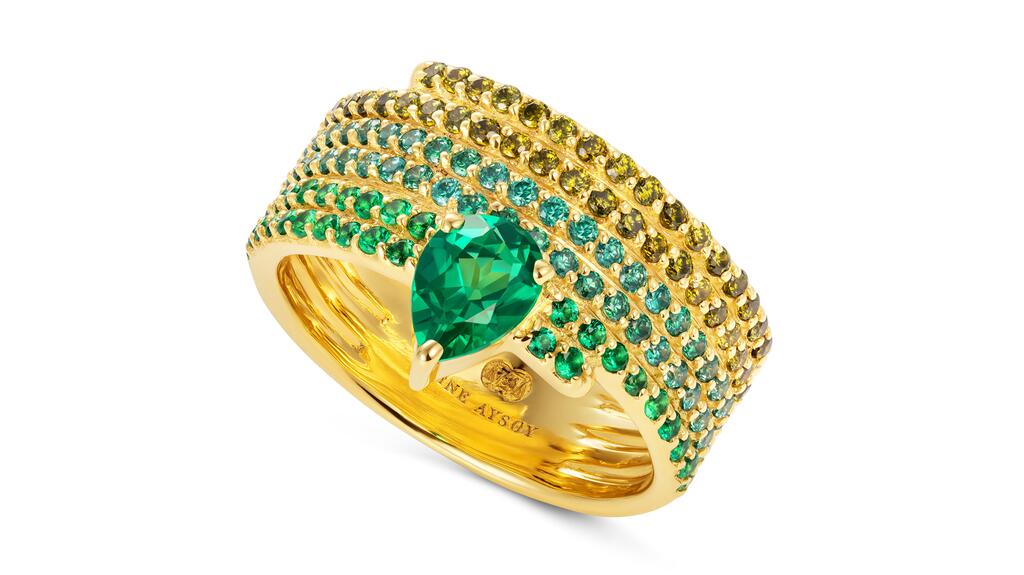 Nadine Aysoy “Le Cercle Cigar Ring” in 18-karat yellow gold with 2.3 carats of emerald, 0.3 carats of green sapphire, and 0.3 carats of peridot