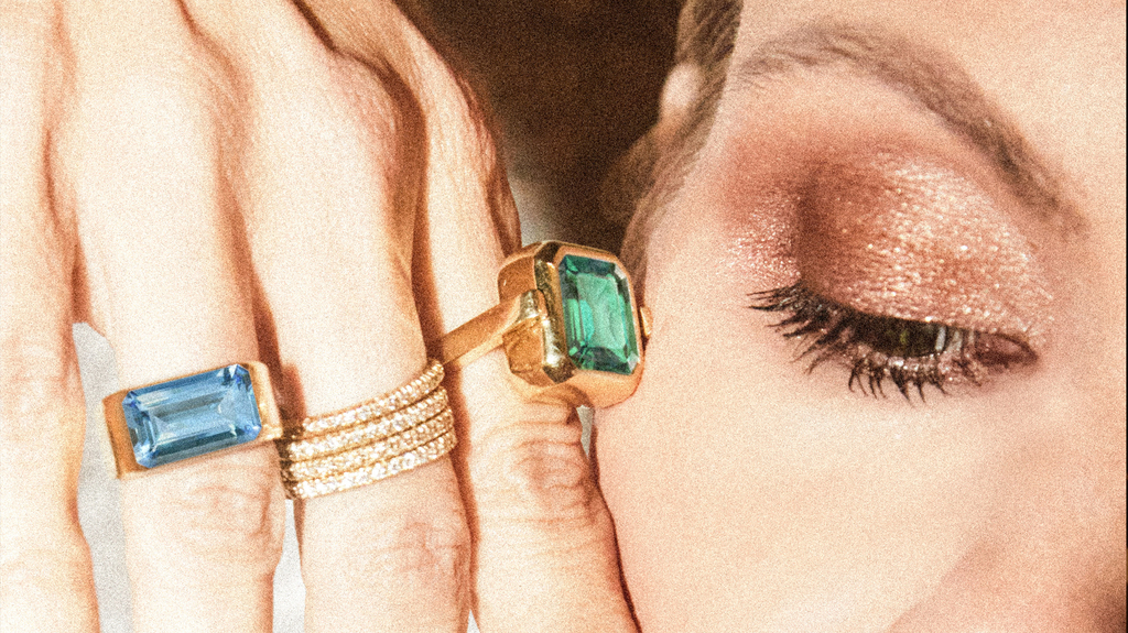 At right is the collection’s swivel ring, which features a different colored gemstone on each side.