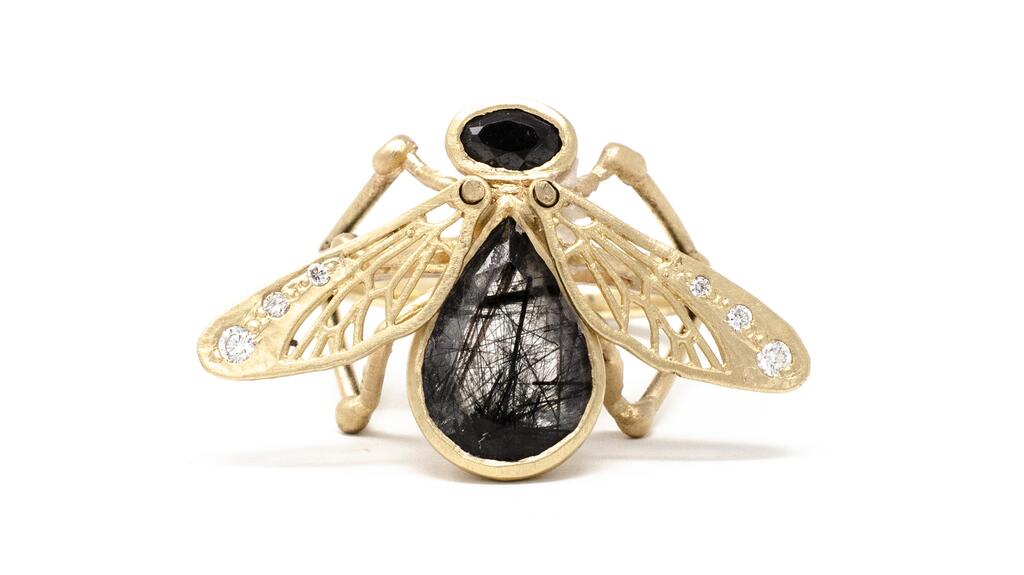 An 18-karat yellow gold fly ring by Jennifer Dawes Design with movable wings, set with a 2-carat rutilated quartz with black sapphire and diamonds ($4,250) Jennifer Dawes Design fly ring