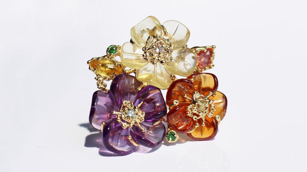 The “Carved Floral Bouquet” ring by Clas with carved tourmaline, quartz, citrine, garnet, peridot, and diamond accents in 18-karat yellow gold ($6,000) Clas Carved Floral Bouquet Ring