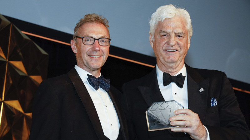 Stephen Lussier, left, accepted the Gem Award for Lifetime Achievement from fellow De Beers executive Charles Stanley. (Photo credit: Bart Gorin)