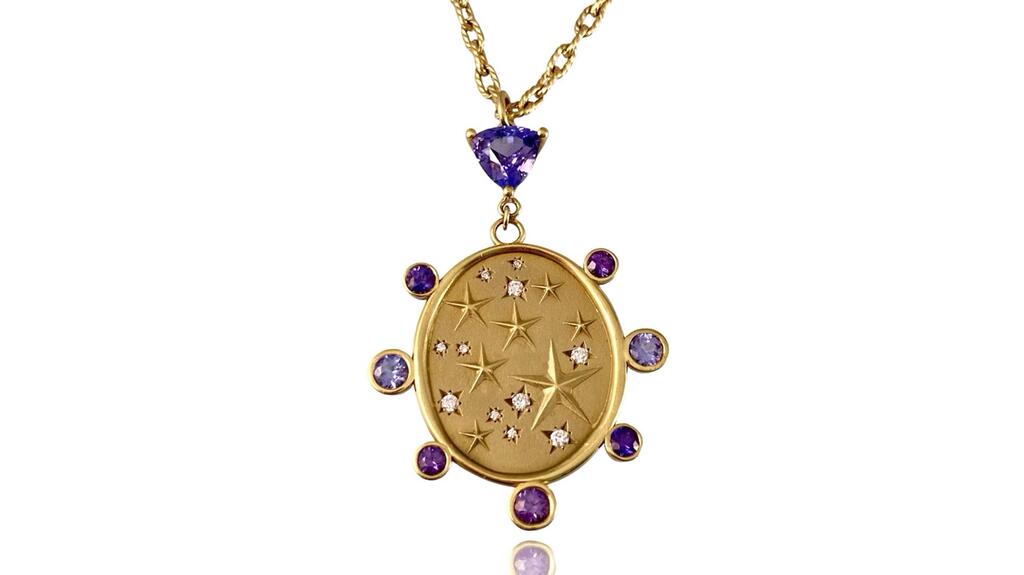 The “Illuminations Shield” pendant by Koulianos Designs with purple and lavender sapphires and diamonds set in 18-karat yellow gold ($8,200) Koulianos Designs Illuminous Sheild Pendant