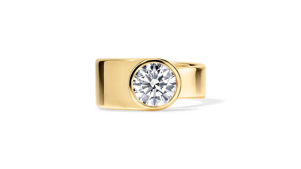 Rosario Navia, designed by Rosario Navia in New York City. An 18-karat yellow gold spiral-inspired engagement ring with a bezel-set 2-carat round brilliant diamond (D/VVS2) ($29,000) Rosaria Navia spital bezel set diamond engagement ring