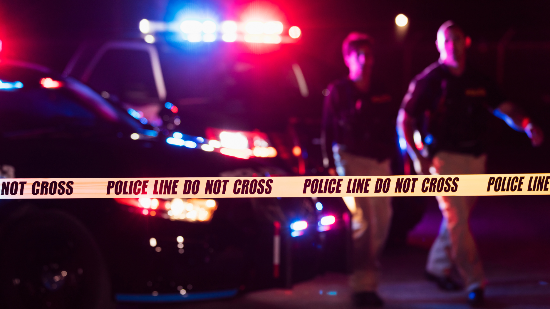 Stock image of police officers and crime scene tape