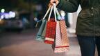 Stock image of hand holding holiday shopping bags