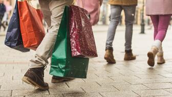 Shoppers holding bags in winter weather